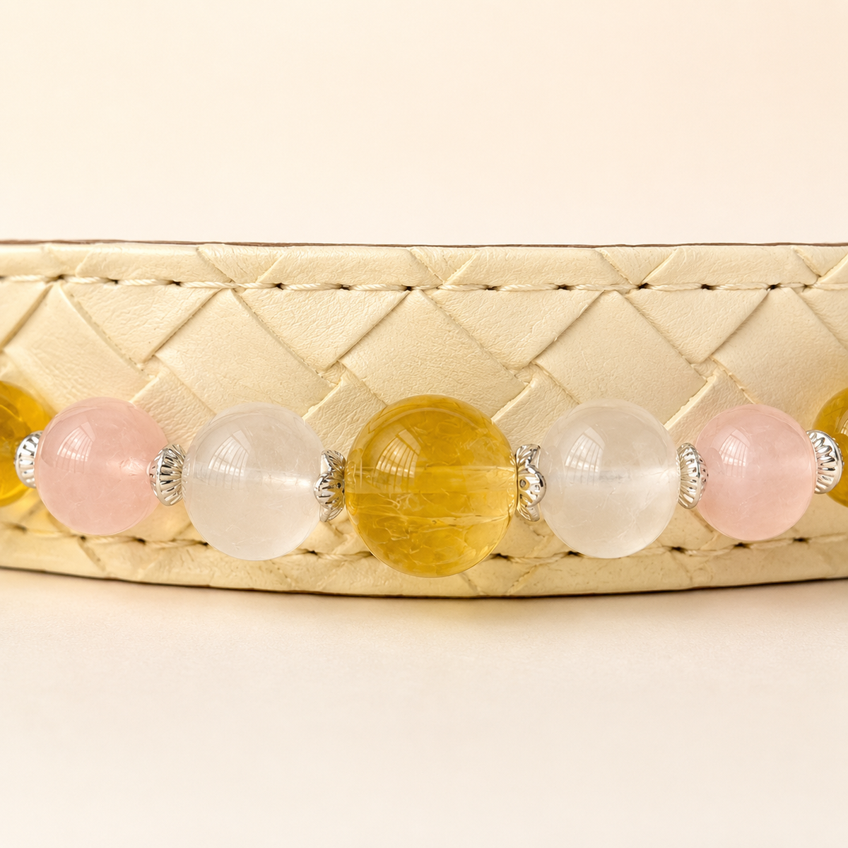 Close-up of the Aurelia Blush collar bead arrangement, decorative settings, and ivory base.