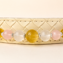 Close-up of the Aurelia Blush collar bead arrangement, decorative settings, and ivory base.