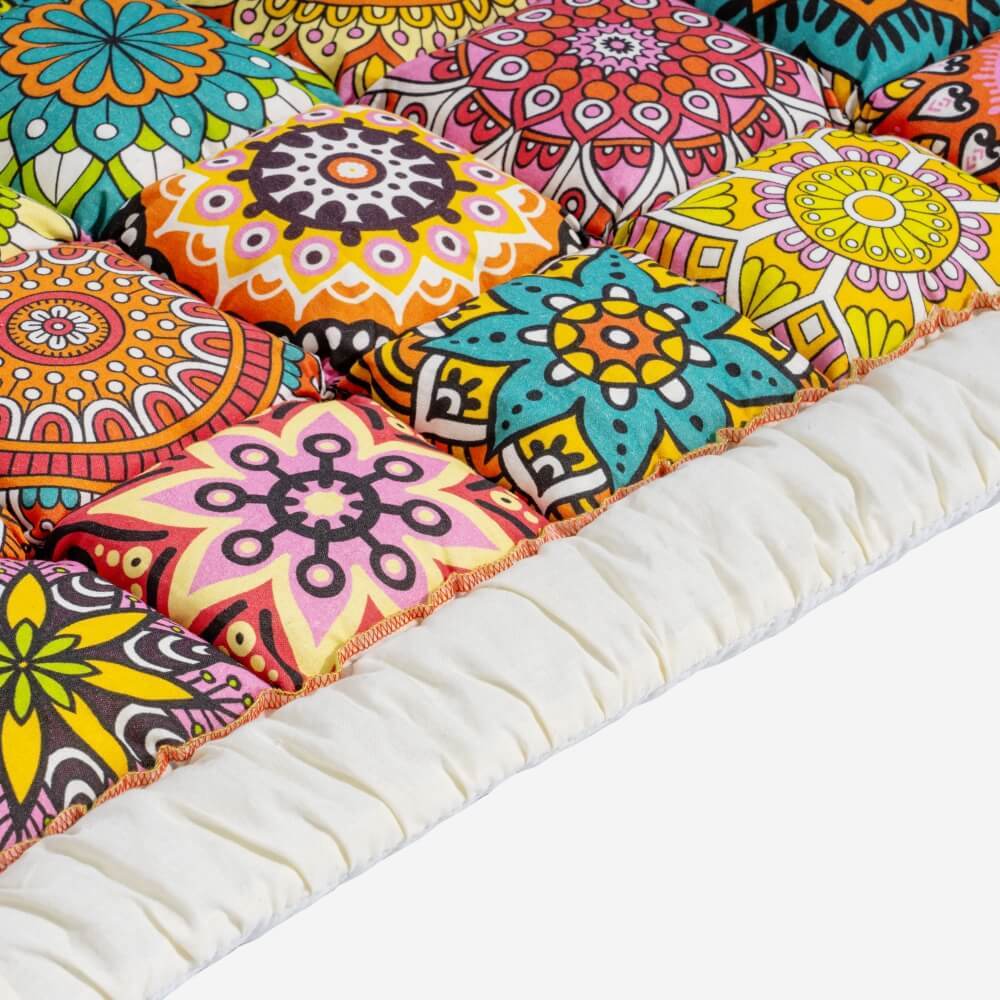Close-up of the Multicolor Mandala quilted cushions and ivory ruffled edge