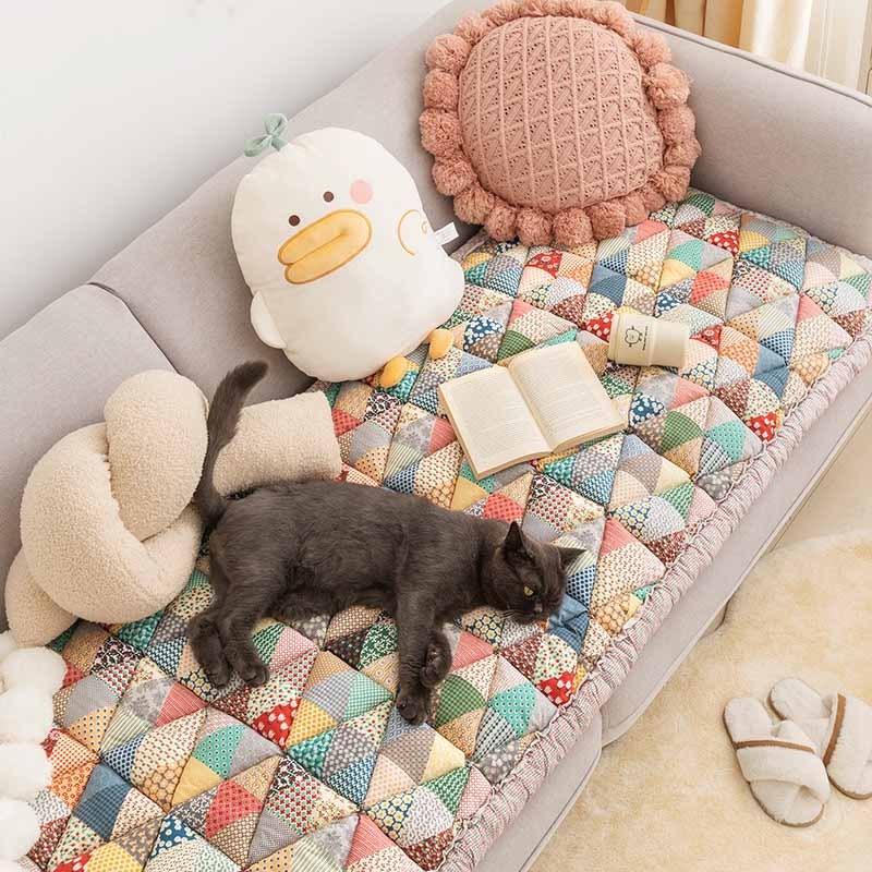 Colorful Triangle Patchwork pet sofa mat with a grey cat