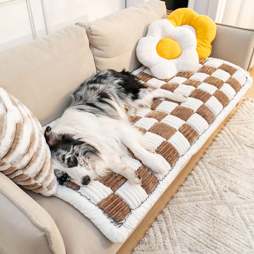 Brown and cream ribbed checkerboard pet sofa mat with a dog resting on it