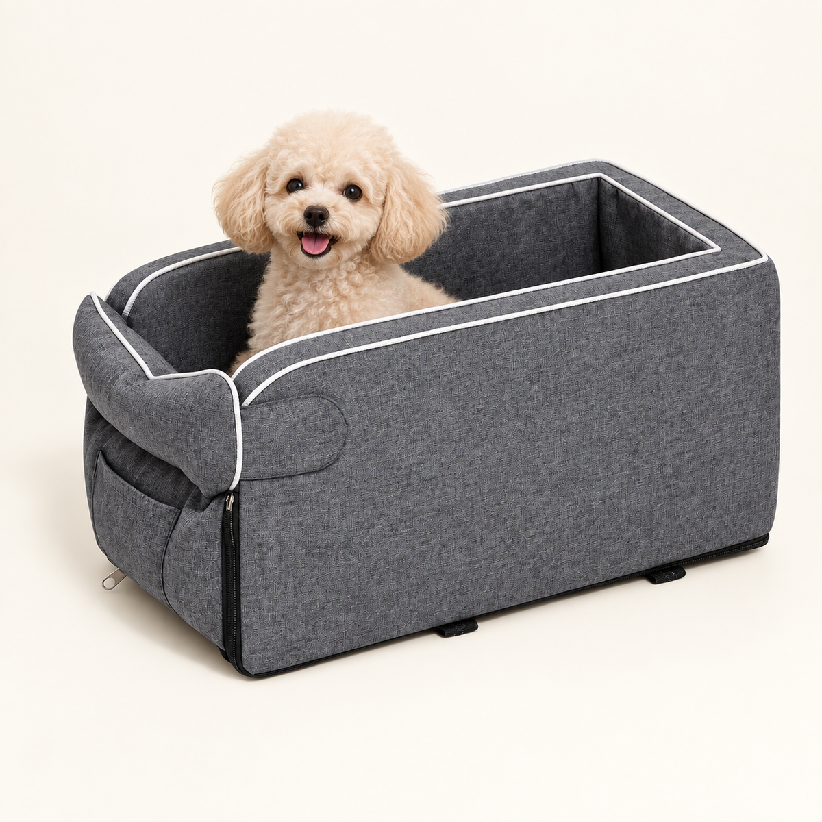 Small cream poodle sitting in the gray console pet seat