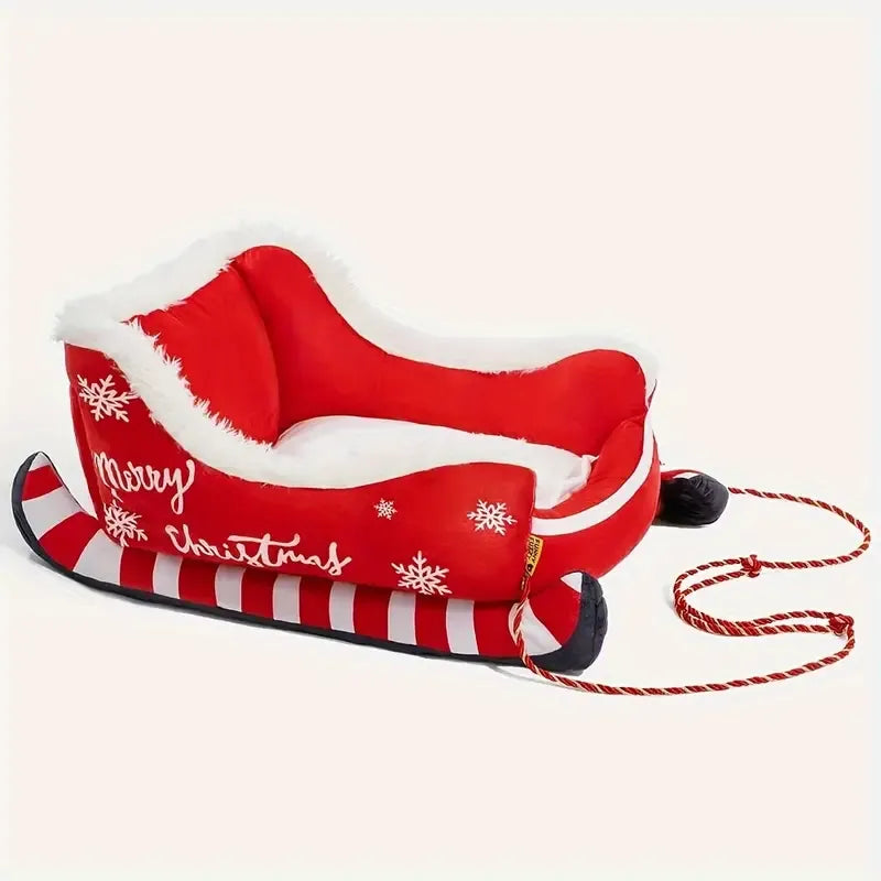 Red sleigh shaped pet bed with a white cushion and Christmas decorations