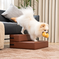 Brown modular faux leather pet stairs, 2-Step configuration, with a Pomeranian beside a sofa