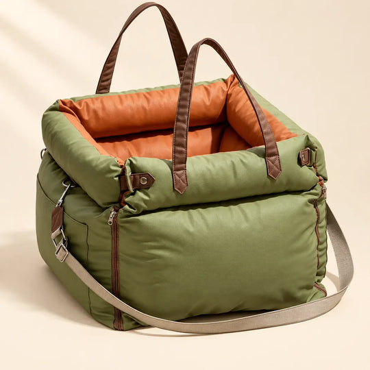 Olive green pet travel carrier with orange lining, brown handles and shoulder strap