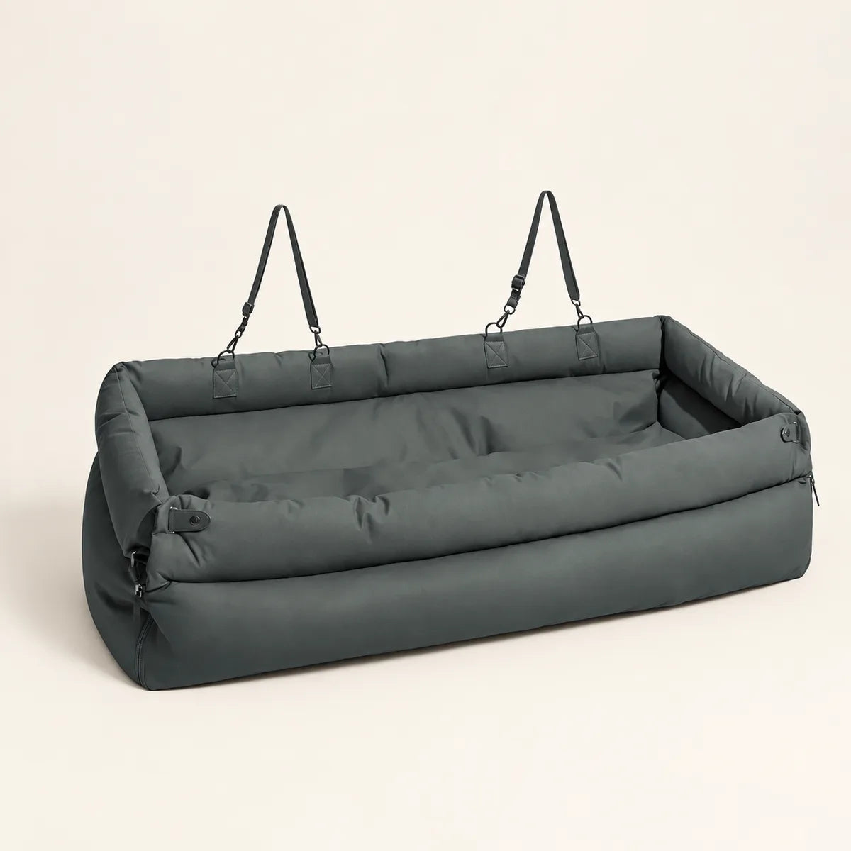 Blue grey long pet car seat bed with padded sides and straps on a warm cream background