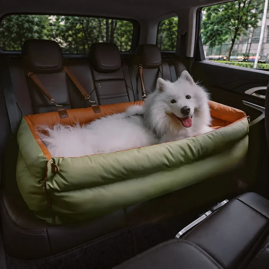 White dog resting on a green and orange long pet bed across a car rear seat