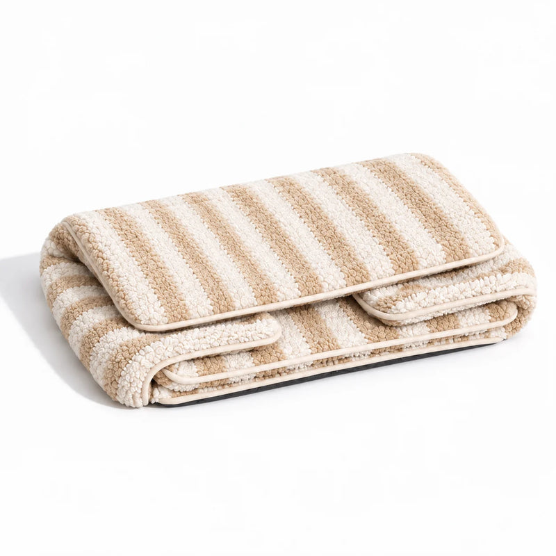 Beige and ivory striped faux lambswool pet sofa shown folded on a white studio background