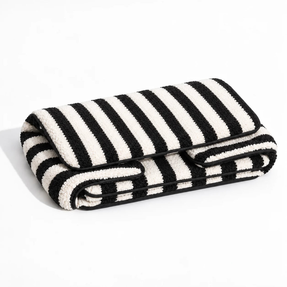 Black and ivory striped faux lambswool pet sofa shown folded on a white studio background