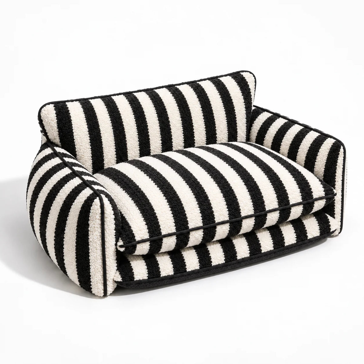 Three-quarter studio view of a black and ivory striped faux lambswool double-layer pet sofa bed on a white background