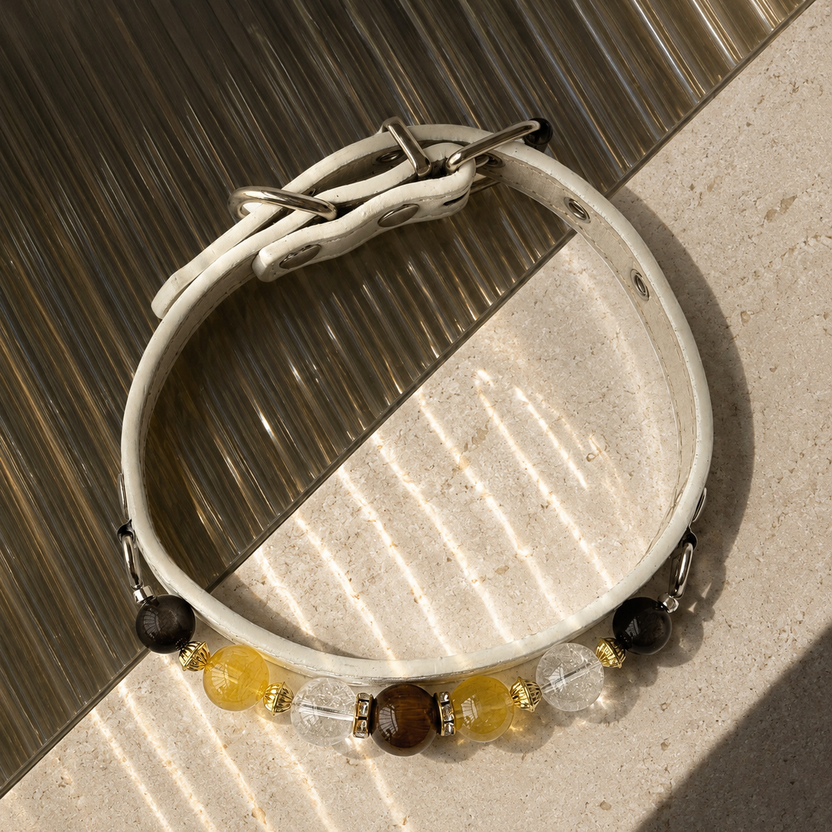 Full Sunlit Halo pet jewelry collar showing its closed shape, white base, hardware, and decorative front.